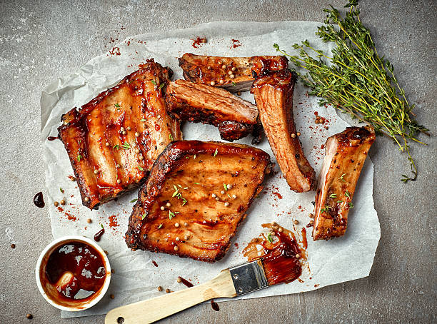 grilled pork ribs grilled pork ribs on white baking paper, top view marinated photos stock pictures, royalty-free photos & images