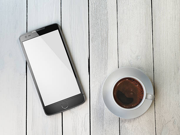 istock Mobile phone and coffee cup on wooden background. 609829574