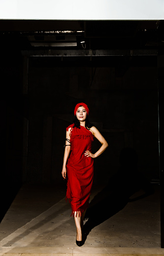 Fashion woman walking in dark room