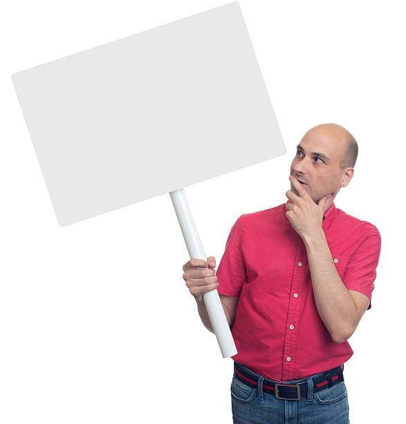 istock man holding a stick with a blank poster. Isolated 609830134