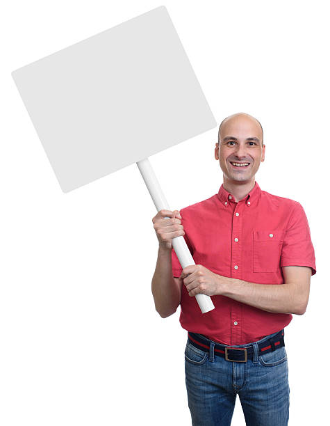 istock smiling bald man holding a blank sign board. 609830288