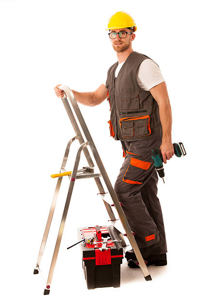 istock Young man worker clombing on metal ladder isolated 609832130
