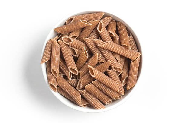 istock Wholemeal Pasta. Integral Penne into a bowl 609833124