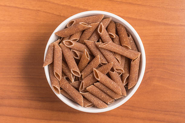istock Wholemeal Pasta. Integral Penne into a bowl 609833334