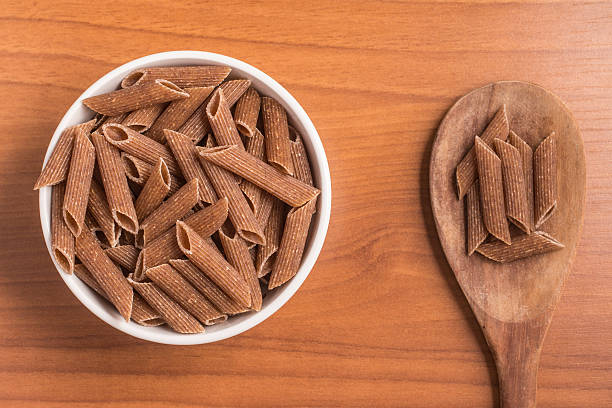 istock Wholemeal Pasta. Integral Penne into a bowl 609833702