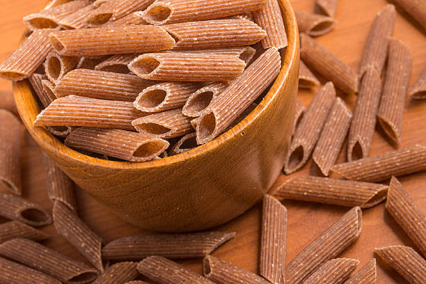 istock Wholemeal Pasta. Integral Penne into a bowl 609834014