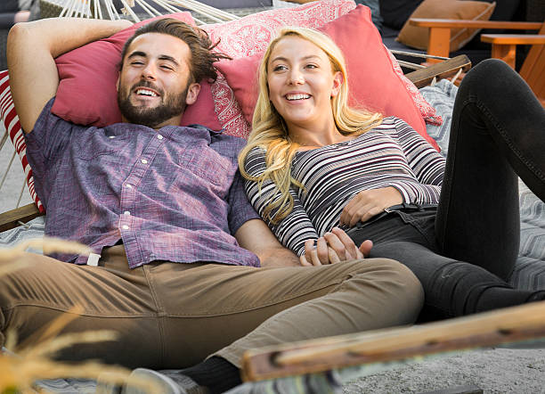 istock Young Couple Relaxing in Urban Public Park Hammock 609835502