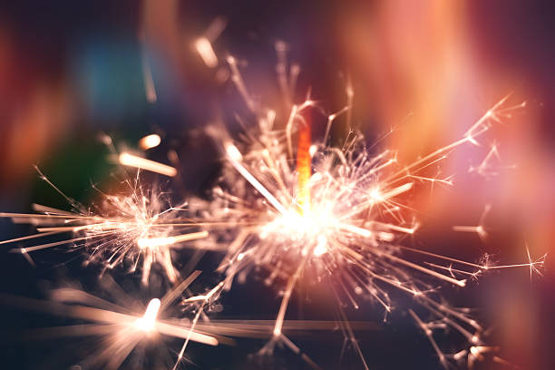 istock Christmas sparkler in haze with red light 609838176
