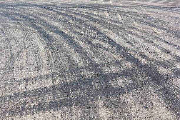 istock Abstract road background with tracks of tires 609838228