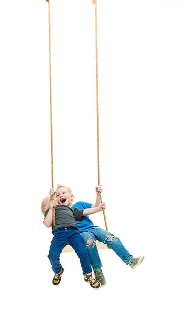 istock Happ little brothers swinging together 609902230