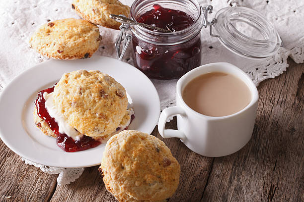 istock Homemade buns with jam and tea with milk close-up. horizontal 609902622