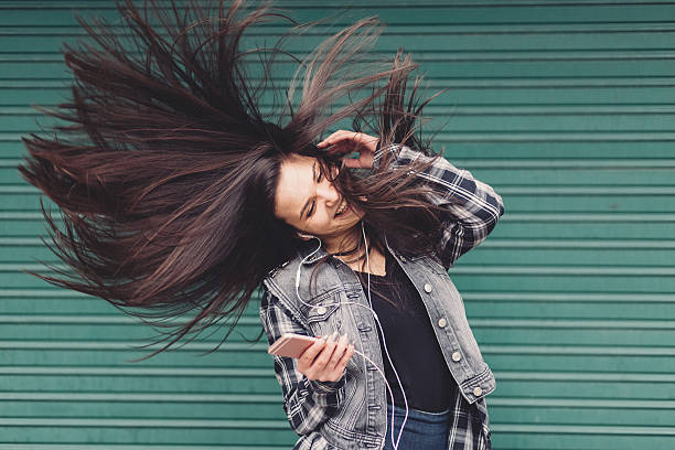 istock Girl shaking head to music 609902668