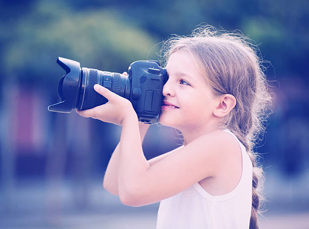 istock girl holding photo camera 609903120