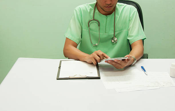 istock Doctor working with tablet at desk 609903130