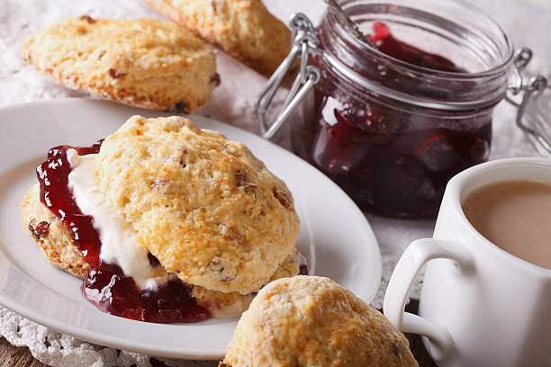 istock English pastries: scones with jam and tea with milk 609903560
