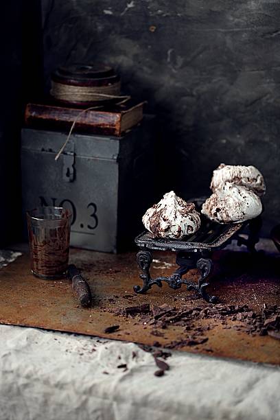 istock chocolate meringues on vintage stand. 609904684