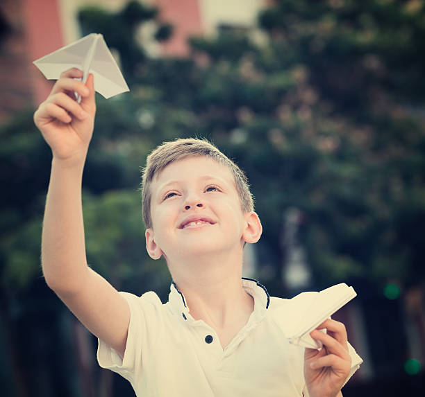 istock boy plaiing with toy airplane 609905074