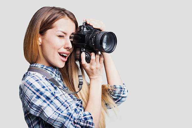 istock Woman photographer with camera 609908040