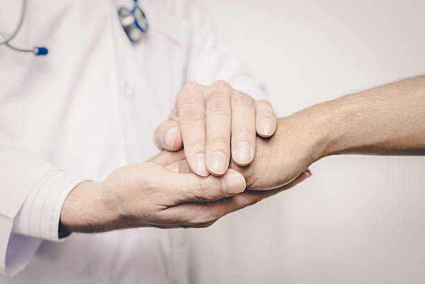 istock Two people holding hands for comfort   , vintage 609910118