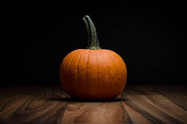 istock Orange pumpkin on wood 609911696