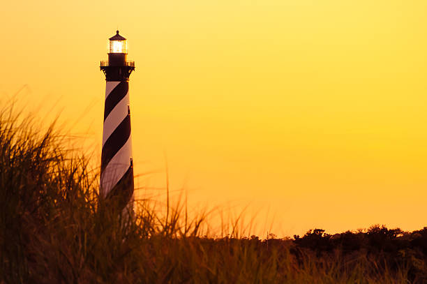 Illuminated  Hatteras Lighthouse Cape Hatteras light house located in North Carolina, taken during at dusk.  cape hatteras stock pictures, royalty-free photos & images