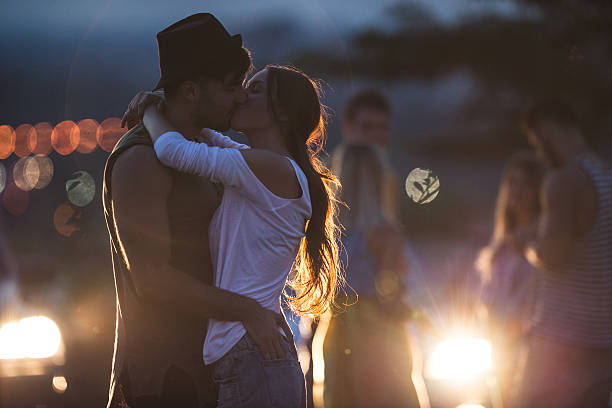 Couple in love kissing while dancing together on an evening party.
