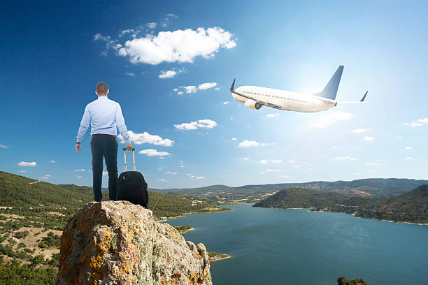 istock Businessman with luggage waiting on peak 609914570