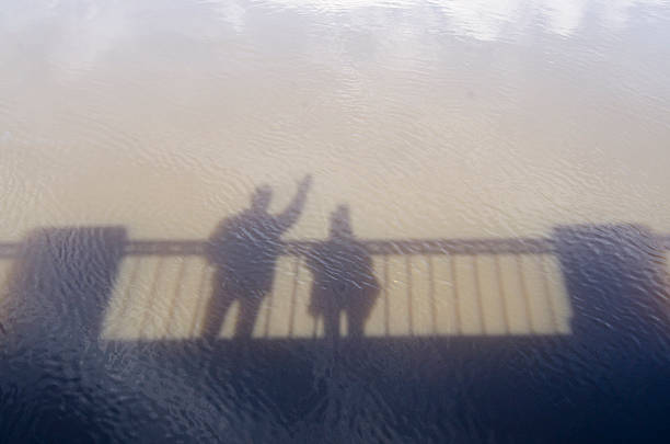 istock Shadows of people on the water 609916002