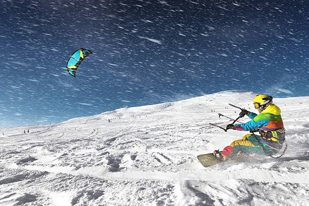 istock Snowboarder snow kite blue sky mountains 609917554
