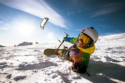 Bright color Snowboarder skydives on blue sky backdrop. Sheregesh, Siberia, Russia