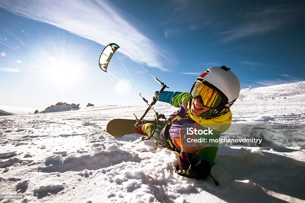 Snowboarder skydives on blue sky backdrop in mountains snowfall Bright color Snowboarder skydives on blue sky backdrop. Sheregesh, Siberia, Russia Extreme Sports Stock Photo