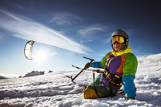 Snowboarder skydives on blue sky backdrop in mountains snowfall