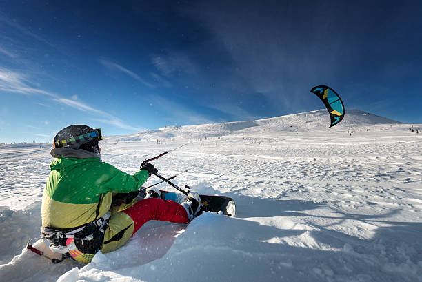 istock Snowboarder skydives on blue sky backdrop in mountains snowfall 609917802