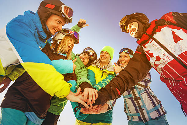 Team of snowboarders stands on blue sky backdrop in mountains Bright color snowboarders stands on blue sky backdrop. Team teamwork concept. Sheregesh ski resort, Siberia, Russia Sheregesh stock pictures, royalty-free photos & images