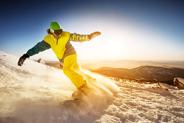 istock Snowboarder rides on the slope snow mountains background 609918450