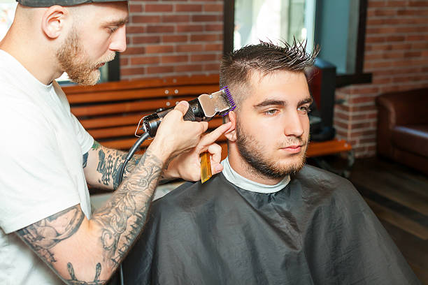 istock Young man having hair cutted 609918680