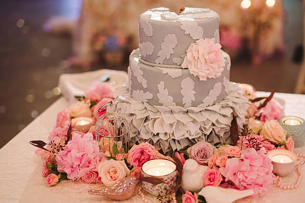 istock wedding cake on decorated table with flowers and candles 609919502