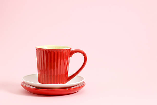 istock Red coffee cup on white and red plate 609921262
