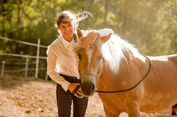istock Young Woman Grooming her Horse 609922902