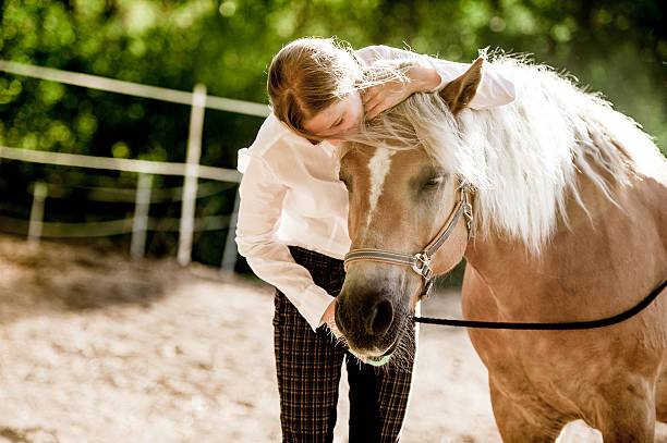 istock Young Woman Embracing her Horse 609922912