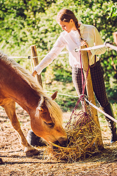 istock Young Woman with her Horse 609923336