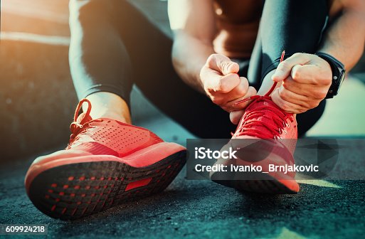 istock Tying sports shoes 609924218