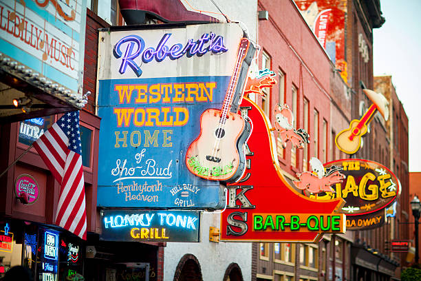 Downtown Nashville music entertainment establishments Nashville, United States - September 23, 2016: View of country western neon signs on Lower Broadway in Nashville, TN.  The district is famous for its country music entertainment and bars. tennessee photos stock pictures, royalty-free photos & images