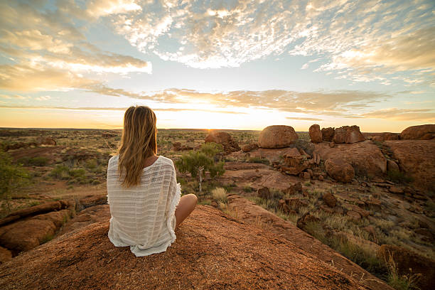 istock Caucasian female meditating at sunrise 609928746