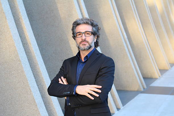 istock Confident mature businessman outside modern office building 609929588