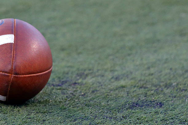 istock football on turf 609930928