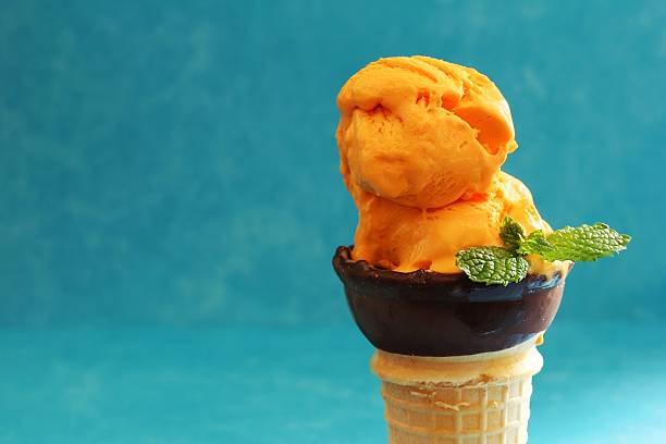 istock Homemade Mango icecream in a cone, selective focus 609931050