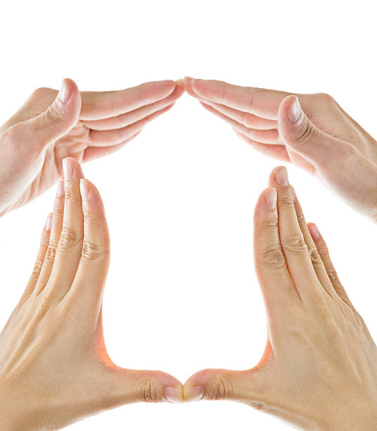 istock Peoples hands forming a home symbol 609931552
