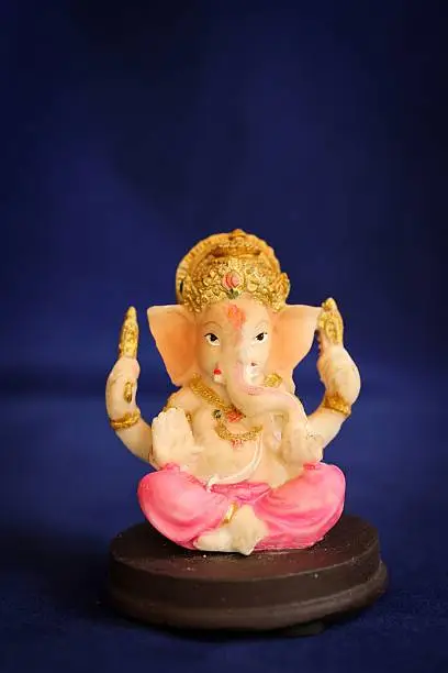 Hindu God Ganesha on dark blue background / Ganesh Chathurthi background with free space for text