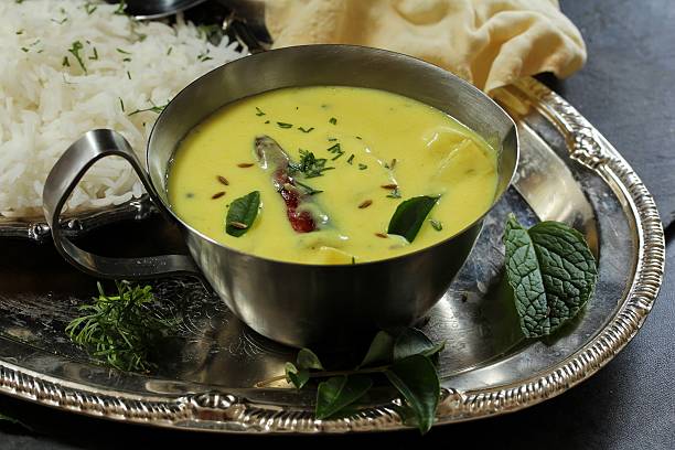 istock Gujarati Kadhi served with rice and papad, selective focus 609931712